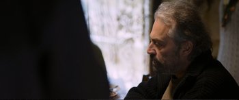 Movie still from “Winter Sleep” (2014), directed by Nuri Bilge Ceylan – An older man sitting in front of a computer screen; Close Up shot, Over the shoulder angle