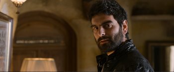 Movie still from “Winter Sleep” (2014), directed by Nuri Bilge Ceylan – A man with a goatee and a beard looking at the camera; Close Up shot, Low angle