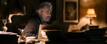 Movie still from “Winter Sleep” (2014), directed by Nuri Bilge Ceylan – An older man sitting in front of a laptop computer; Medium shot, Over the shoulder angle