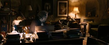Movie still from “Winter Sleep” (2014), directed by Nuri Bilge Ceylan – Two people sitting on a couch looking at a computer; Wide shot, Over the shoulder angle
