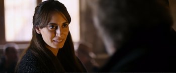 Movie still from “Winter Sleep” (2014), directed by Nuri Bilge Ceylan – A beautiful woman with long black hair smiling for the camera; Close Up shot, Over the shoulder angle