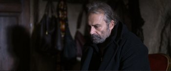 Movie still from “Winter Sleep” (2014), directed by Nuri Bilge Ceylan – An older man with a beard and a black jacket; Close Up shot, Over the shoulder angle