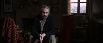 Movie still from “Winter Sleep” (2014), directed by Nuri Bilge Ceylan – An older man sitting on a chair in a room; Medium shot, Over the shoulder angle