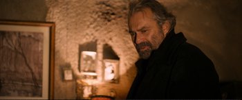 Movie still from “Winter Sleep” (2014), directed by Nuri Bilge Ceylan – A man with a goatee standing in a room; Close Up shot, Over the shoulder angle