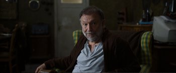 Movie still from “Winter Sleep” (2014), directed by Nuri Bilge Ceylan – An older man sitting in a chair in a living room; Close Up shot, High angle
