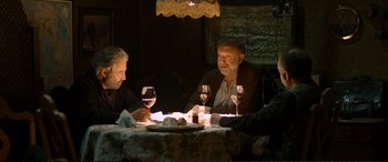 Movie still from “Winter Sleep” (2014), directed by Nuri Bilge Ceylan – A group of people sitting at a table with wine glasses; Medium shot, High angle