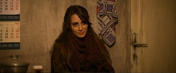 Movie still from “Winter Sleep” (2014), directed by Nuri Bilge Ceylan – A woman wearing a brown scarf and a brown jacket; Close Up shot, Over the shoulder angle