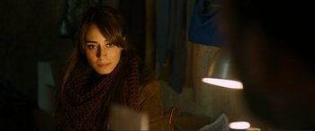 Movie still from “Winter Sleep” (2014), directed by Nuri Bilge Ceylan – A woman sitting at a table in a dark room; Close Up shot, Over the shoulder angle