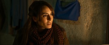 Movie still from “Winter Sleep” (2014), directed by Nuri Bilge Ceylan – A woman wearing a brown scarf sitting on top of a couch; Close Up shot, Over the shoulder angle