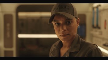 Movie still from “Another Life” (2019), created by Aaron Martin – A woman wearing a hat and a shirt; Close Up shot, Low angle