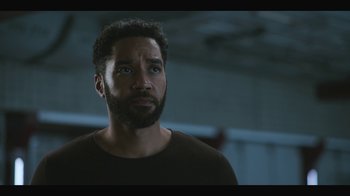 Movie still from “Another Life” (2019), created by Aaron Martin – A person with a beard; Close Up shot, Low angle