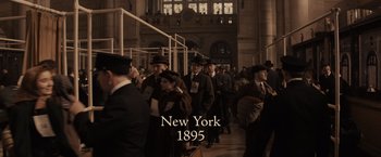 Movie still from “Winter's Tale” (2014), directed by Akiva Goldsman – A group of people walking down a train platform; Wide shot, High angle