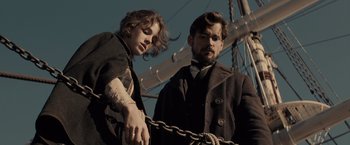 Movie still from “Winter's Tale” (2014), directed by Akiva Goldsman – A man standing next to a woman on a boat; Medium shot, Low angle