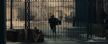 Movie still from “Winter's Tale” (2014), directed by Akiva Goldsman – A man standing in front of an iron gate; Extreme Wide shot, High angle