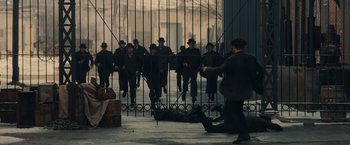 Movie still from “Winter's Tale” (2014), directed by Akiva Goldsman – A man kneeling down in front of a group of people; Wide shot, High angle