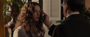 Movie still from “Winter's Tale” (2014), directed by Akiva Goldsman – A woman getting her hair cut by a barber; Close Up shot, Over the shoulder angle