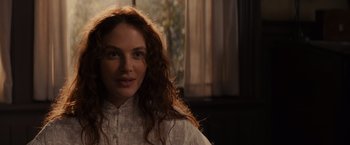 Movie still from “Winter's Tale” (2014), directed by Akiva Goldsman – A woman with long red hair wearing a white shirt; Close Up shot, Over the shoulder angle