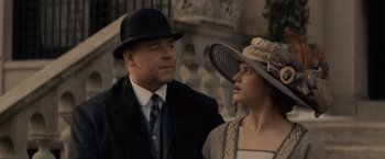 Movie still from “Winter's Tale” (2014), directed by Akiva Goldsman – A man and a woman wearing hats and a suit; Close Up shot, Low angle