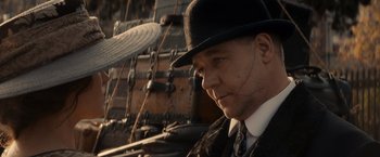Movie still from “Winter's Tale” (2014), directed by Akiva Goldsman – A man wearing a hat and a tie; Close Up shot, Low angle