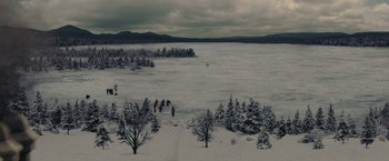 Movie still from “Winter's Tale” (2014), directed by Akiva Goldsman – A group of people walking across a snow covered lake; Extreme Wide shot, High angle