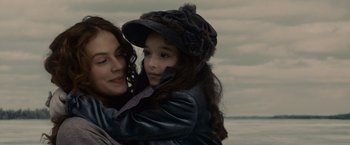 Movie still from “Winter's Tale” (2014), directed by Akiva Goldsman – A woman and a child are posing for a picture; Close Up shot, Over the shoulder angle