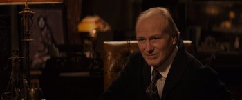 Movie still from “Winter's Tale” (2014), directed by Akiva Goldsman – An older man sitting in a chair in a room; Close Up shot, Over the shoulder angle
