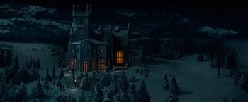 Movie still from “Winter's Tale” (2014), directed by Akiva Goldsman – An illuminated castle in the middle of a snowy field; Extreme Wide shot, High angle