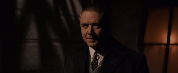 Movie still from “Winter's Tale” (2014), directed by Akiva Goldsman – A person wearing a suit and tie; Close Up shot, Low angle