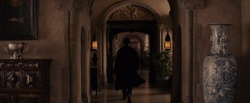 Movie still from “Winter's Tale” (2014), directed by Akiva Goldsman – A man walking through a hallway in a building; Wide shot, Over the shoulder angle
