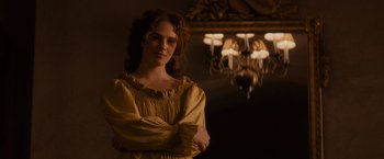 Movie still from “Winter's Tale” (2014), directed by Akiva Goldsman – A woman standing in front of a chandelier; Medium shot, Over the shoulder angle