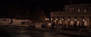 Movie still from “Winter's Tale” (2014), directed by Akiva Goldsman – People are walking on a snowy sidewalk at night; Extreme Wide shot, High angle