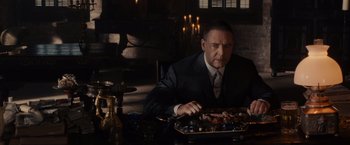 Movie still from “Winter's Tale” (2014), directed by Akiva Goldsman – A man sitting at a table with a tray of food; Medium shot, Low angle