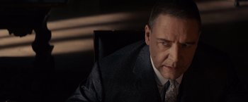 Movie still from “Winter's Tale” (2014), directed by Akiva Goldsman – A person wearing a suit and tie; Close Up shot, Low angle