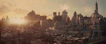 Movie still from “Winter's Tale” (2014), directed by Akiva Goldsman – A view of a city skyline at sunset with smoke billowing from the buildings; Extreme Wide shot, High angle