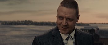 Movie still from “Winter's Tale” (2014), directed by Akiva Goldsman – A person wearing a suit and tie; Close Up shot, Over the shoulder angle