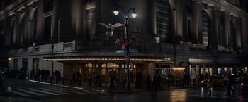 Movie still from “Winter's Tale” (2014), directed by Akiva Goldsman – People are walking on the sidewalk in front of a theater; Extreme Wide shot, Low angle