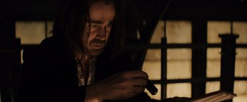Movie still from “Winter's Tale” (2014), directed by Akiva Goldsman – A man with long hair looking at a cell phone; Close Up shot, Low angle