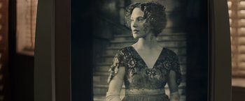 Movie still from “Winter's Tale” (2014), directed by Akiva Goldsman – An old photo of a woman wearing a dress; Close Up shot, Low angle