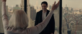 Movie still from “Winter's Tale” (2014), directed by Akiva Goldsman – A man and a woman high - fiving each other in front of a city skyline; Medium shot, Over the shoulder angle