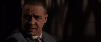 Movie still from “Winter's Tale” (2014), directed by Akiva Goldsman – A person wearing a suit and tie; Close Up shot, Over the shoulder angle