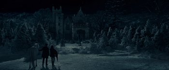 Movie still from “Winter's Tale” (2014), directed by Akiva Goldsman – A person walking in front of an old castle; Extreme Wide shot, High angle