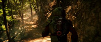 Movie still from “Wish I Was Here” (2014), directed by Zach Braff – A man in a helmet is walking down a trail; Wide shot, Over the shoulder angle