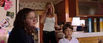 Movie still from “Wish I Was Here” (2014), directed by Zach Braff – A woman drinking a cup of coffee in a kitchen; Medium shot, Over the shoulder angle