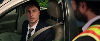 Movie still from “Wish I Was Here” (2014), directed by Zach Braff – A man sitting in the driver's seat of a car; Close Up shot, Over the shoulder angle