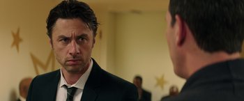 Movie still from “Wish I Was Here” (2014), directed by Zach Braff – A man in a suit and tie looking at a man in a suit and tie; Close Up shot, Over the shoulder angle