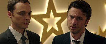 Movie still from “Wish I Was Here” (2014), directed by Zach Braff – A man in a suit standing next to another man in a suit; Close Up shot, Over the shoulder angle