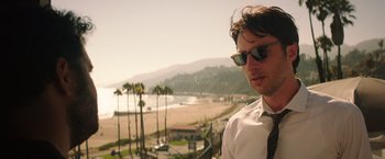 Movie still from “Wish I Was Here” (2014), directed by Zach Braff – A man in a white shirt and tie standing in front of the ocean; Close Up shot, Low angle