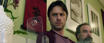 Movie still from “Wish I Was Here” (2014), directed by Zach Braff – A person in a room looking at the camera; Close Up shot, Over the shoulder angle