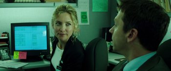 Movie still from “Wish I Was Here” (2014), directed by Zach Braff – A woman sitting at a desk in front of a man; Close Up shot, Over the shoulder angle