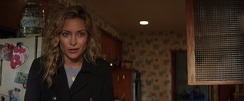 Movie still from “Wish I Was Here” (2014), directed by Zach Braff – A person wearing a jacket in a room; Close Up shot, Over the shoulder angle